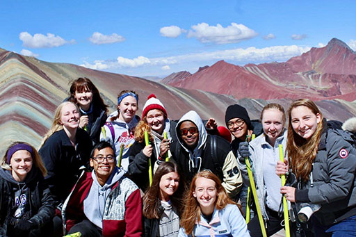 group of intl students standing in front of mountains