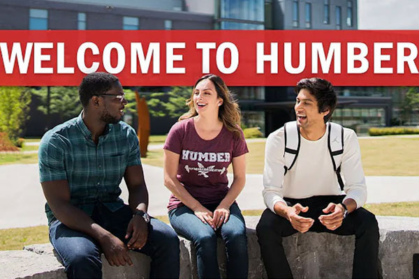 students sitting on bench in front of Humber College