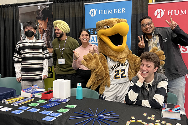 group of humber students posing in front of a math and writing centre booth